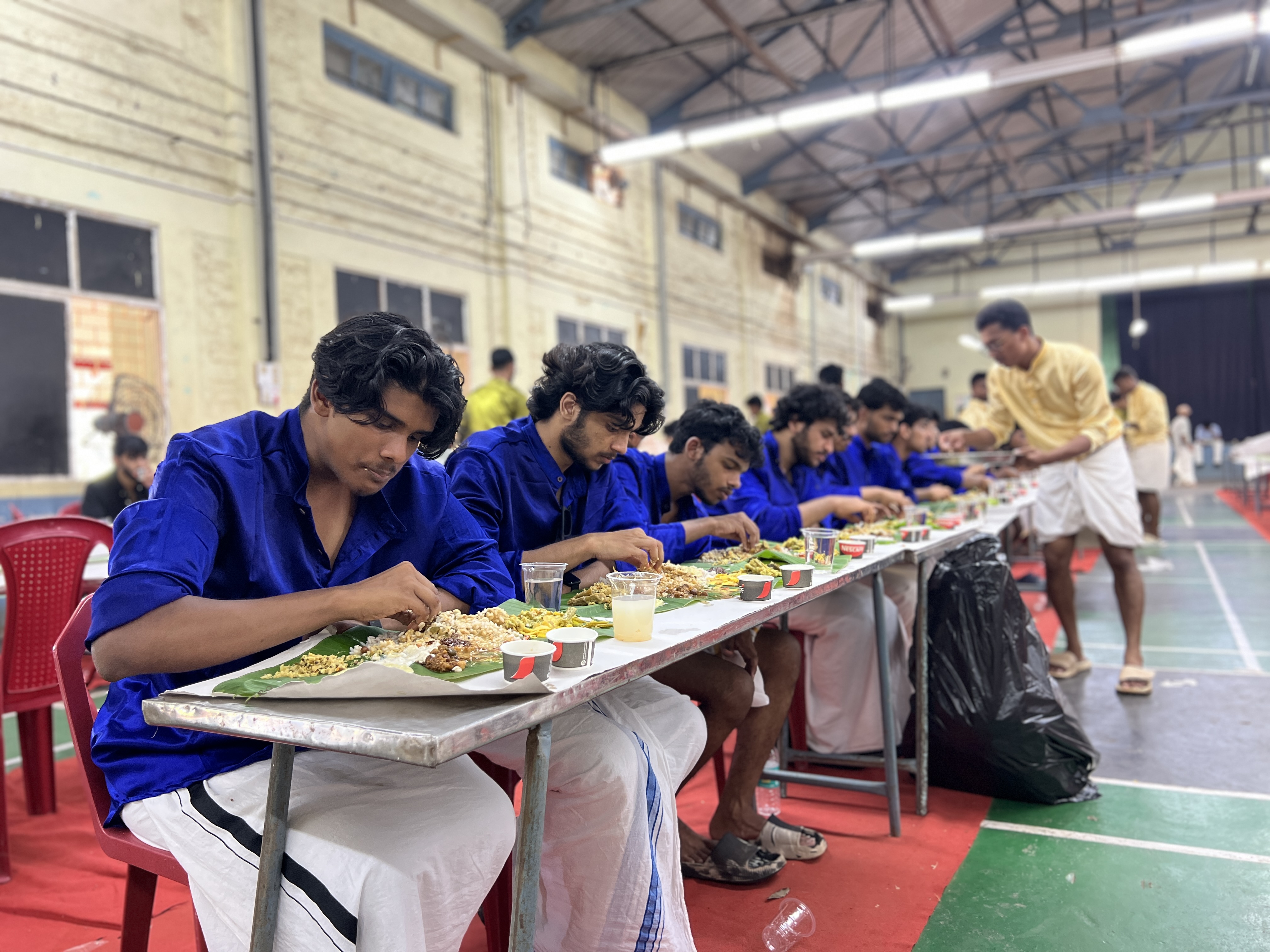 Students enjoying the traditional Onam feast